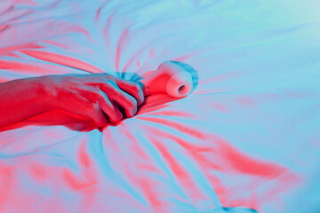 Contactless Clitoral Stimulator Woman in bedroom holding vibrator in hand.