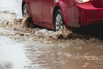 Car stuck in the mud, car wheel in dirty puddle, rough terrain