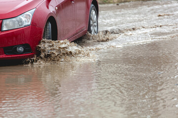 Car stuck in the mud, car wheel in dirty puddle, rough terrain