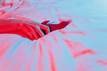 Woman in bedroom holding vibrator in hand.