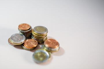 Stack of coins on light background. Blank space