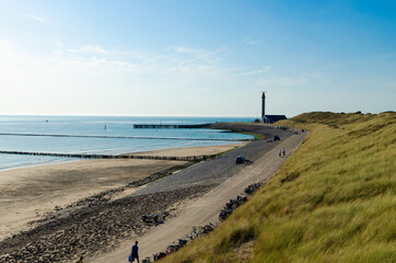 Westkapelle, Netherlands, August 2019. The beaches of this location are wide and clean: on a beautiful sunny day, the bike path along the sea has many bikes parked. The lighthouse in the background.