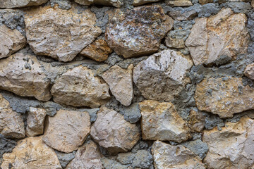 Elements of masonry of a stone wall made of natural stone, with the use of lime mortar.