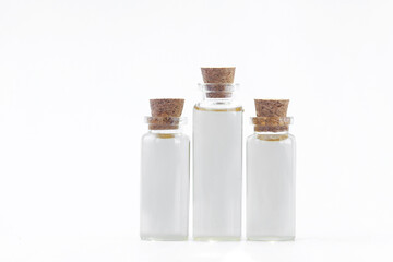 Essence of flowers on white background in beautiful glass Bottle