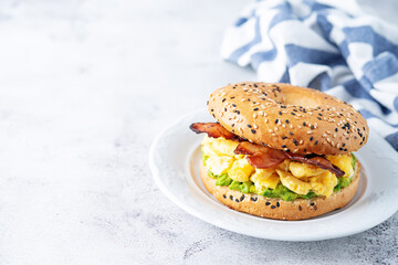 Fried bacon avocado cheese egg salad  bagel