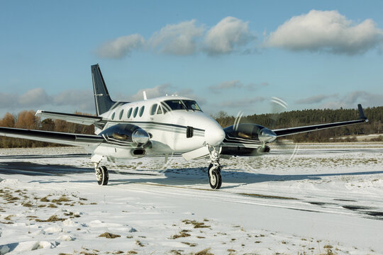 DLOUHA LHOTA, CZECH REP - JAN 27, 2021. Beechcraft BE A90 King Air (OK-SIL) rolls on a snowy runway at the airport in Pr&iacute;bram, Czech Republic