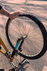 Naklejka premium Man repairs Bicycle wheel, punctured