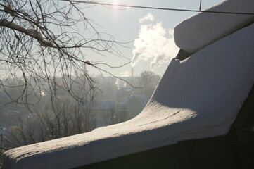 Russian winter: the snow-covered roof of the hut