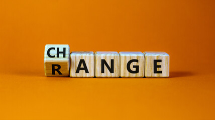 Change range symbol. Turned a cube and changed the word 'change' to 'range'. Beautiful orange background. Copy space. Business and change range concept.