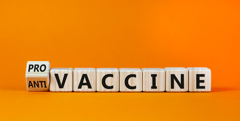 Pro-vaccine or anti-vaccine symbol. Turned a cube, changed words 'anti-vaccine' to 'pro-vaccine'. Beautiful orange background. Copy space. Medical covid-19 pro-vaccine or anti-vaccine concept.