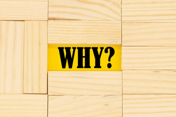 the word why among the wooden blocks. Concept of doubts and questions