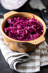 Obraz na płótnie Canvas Red sauerkraut. Sour pickled cabbage in bowl.
