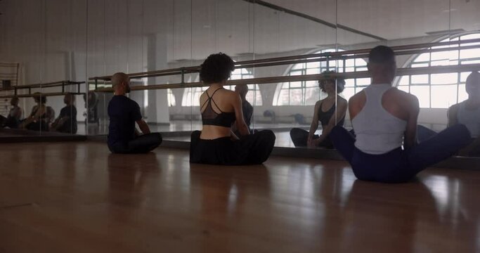 Teacher and students meditating in studio