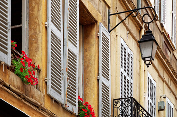 Fototapeta na wymiar Part of facade of a yellow building in Aix-en-Provence, France