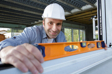 worker checks the level of a window