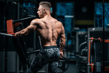 Fototapeta na wymiar young sportsman bodybuilder with muscle body in gym
