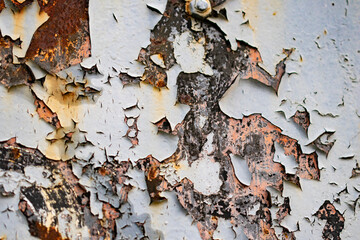 Grunge background with old peeling and flaking paint closeup on rusty metal