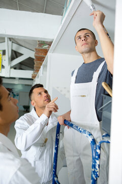 young painter doing the ceiling