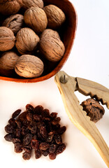 nutcracker breaking a walnut and a lot of raisins