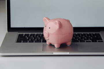 Piggy bank with laptop. Online business concept.