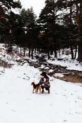 Woman playing with her dog near a river