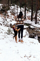 Woman with hat accompanied by her dog
