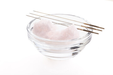 Silver needles for traditional Chinese acupuncture medicine. White background. There is some free...