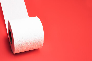 Roll of toilet paper on a red background.