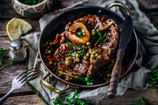 Veal ossobucco with green peas.selective focus