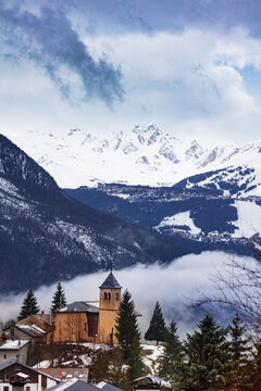 Panorama with Church in Champagny-en-Vanoise village in France and view on Courchevel at winter