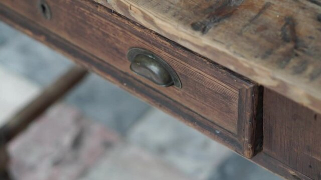 A closeup shot of an old vintage wooden table locked drawer in HD