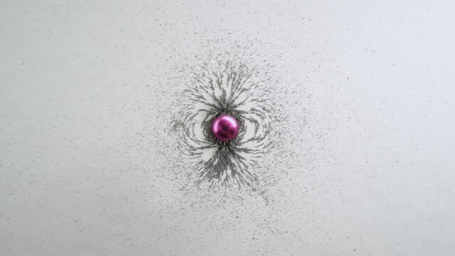 Example Of Magnetic Field Around An Object, With Pink Magnet And Iron Filings