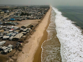 An aerial shot of a beach settlement and the ocean shore