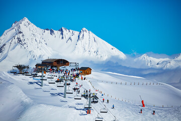 Ski station on top of the high mountain in Les Arcs region of Alps with chairlifts and snow peaks...
