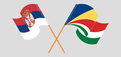 Crossed and waving flags of Serbia and Seychelles