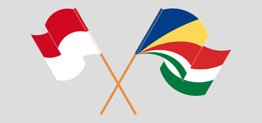 Crossed and waving flags of Monaco and Seychelles