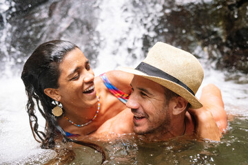 Young couple in love at the waterfall in Costa Rica