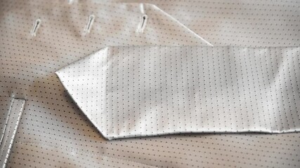 Elegant gray tie with white patterned textures. A gray and white tie on a bed. with garnet texture
