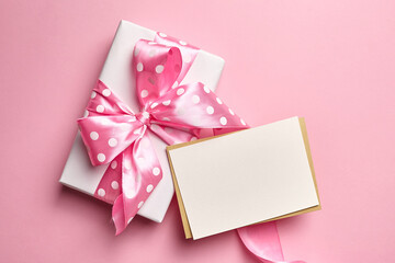 Greeting card mockup with gift box on pink background