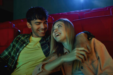 Portrait of happy couple, young man and woman looking at each other, laughing together, holding...