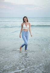 Young slim beautiful woman on sunset beach
