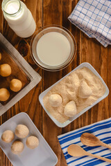 Brazilian uncooked breading croquettes (coxinhas de frango) on a wooden kitchen table - Top view