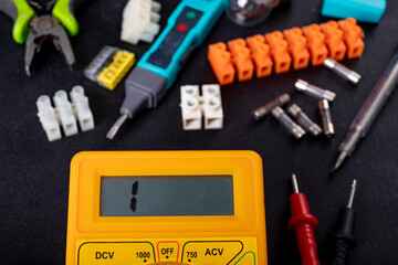 A meter for electrical measurements on a workbench. Accessories for repair and installation of...