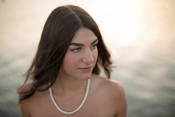 Young slim beautiful woman on sunset beach