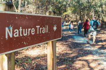 family friends going hiking on a nature trail in autum