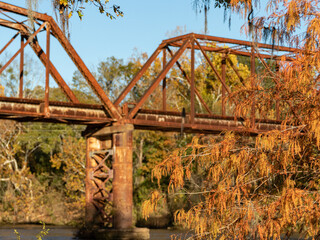 rusted bridge over a river in autum