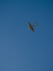 airplane flying in a cloudless blue sky