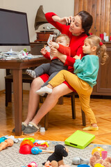 Mother with two child at home. Kids crying. Childcare and working mom. Woman talk by phone. Toddler...