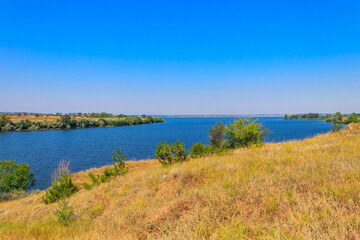 Summer landscape with beautiful river, green trees and blue sky