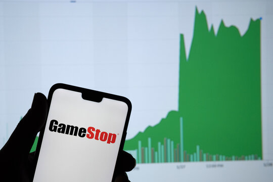 Gamestop retail company logo on the smartphone and its authentic stock price chart for the last 5 days. Stafford, United Kingdom - January 27 2021.